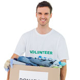 Volunteer carrying a box of donated clothing represents Phoenix Innovates culture of giving back
